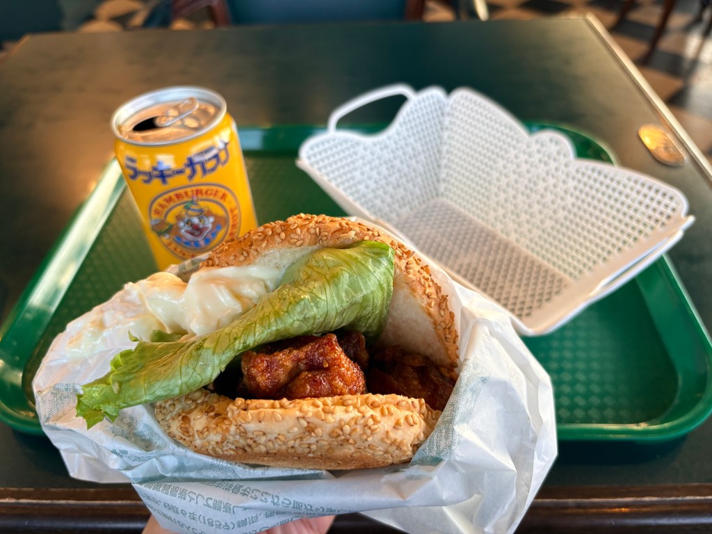 A close-up of a Chinese Chicken Burger with fried chicken and lettuce.