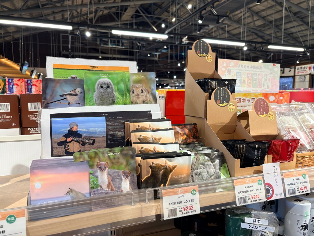 Hand-drip coffee packets featuring illustrations of cute Hokkaido birds and animals on the shelf.