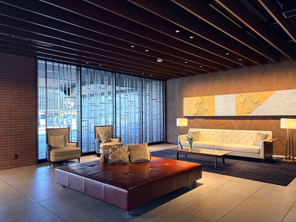 Elegant seating area in the lobby of Hakodate Kokusai Hotel with a large leather ottoman, modern sofas, and warm lighting.